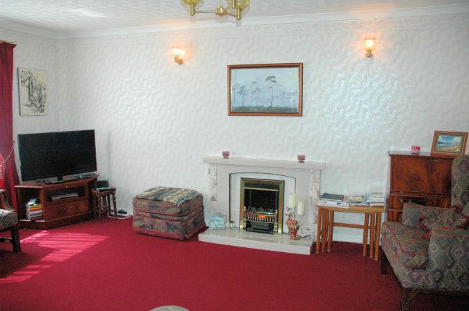 The lounge in Strathardle is comfortable, spacious and light and has large sliding French doors leading directly into the conservatory.