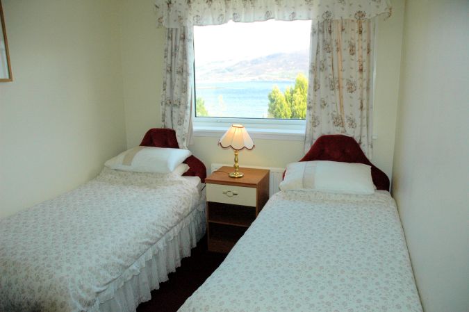 The twin bedroom in Strathardle is at the front of the house and enjoys superb views across Loch Carron.