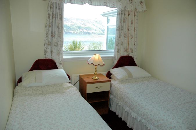 The twin bedroom in Strathardle is at the front of the house and enjoys superb views across Loch Carron.